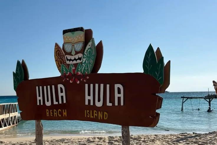 Hula Hula Island sign on the white sand beach by the sea