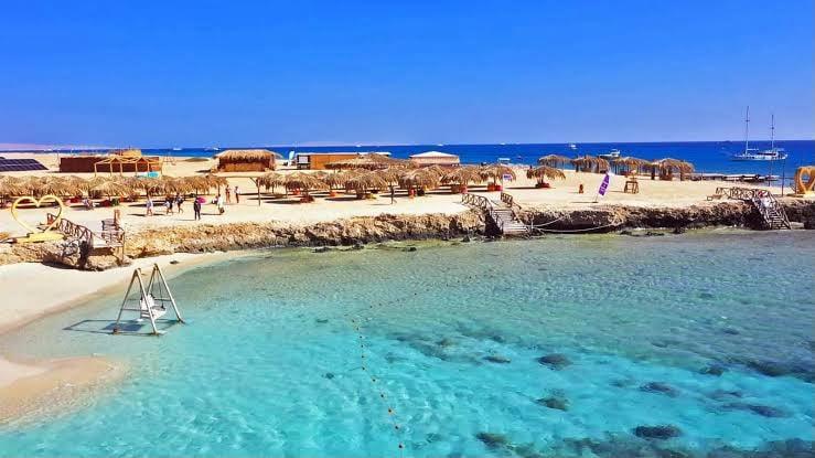 Turquoise lagoon and beach umbrellas on Magawish Island off Hurghada